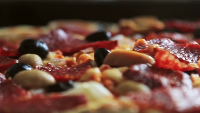 freshly baked pizza with salami, mushrooms and cheese. slider video