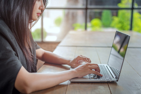 Young businesswoman working with laptop in cafe