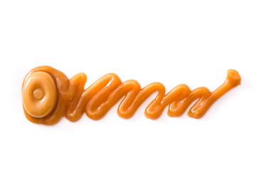 Toffee caramel candy and caramel sauce isolated on white background. Copyspace.

