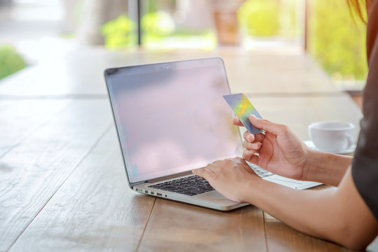Businesswoman holding credit card, shopping online