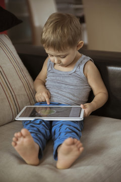 Little Boy Playing On The Tablet