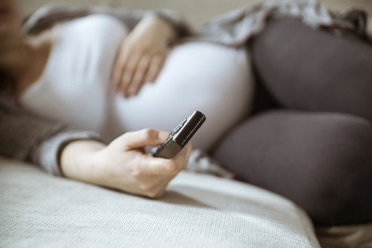 Pregnant Woman Changing Channels