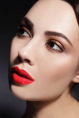Close-up portrait of beautiful woman with red lipstick