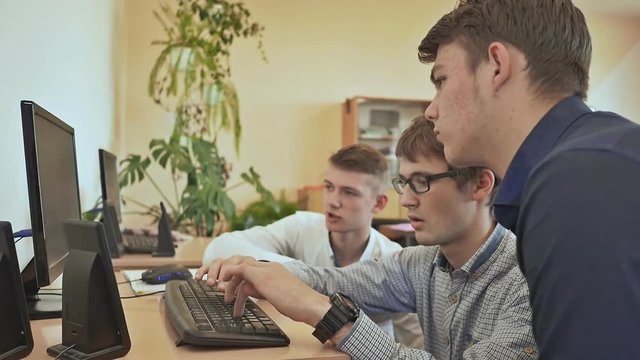 High school students are puzzled by the task at the computer. Russian school.