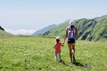 Fototapeta na wymiar Tourist girls mother and daughter walking in mountain landscape