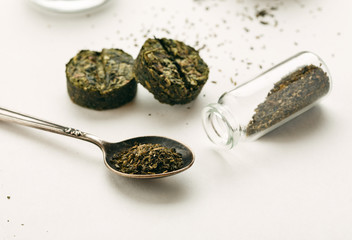 Fototapeta na wymiar Different dry green tea on a white background