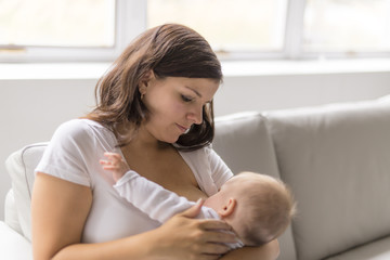 Obraz na płótnie Canvas mother Breast feeding his baby at home