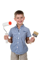 Happy kid boy holding paint roller and a brush, isolated on white background