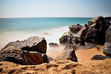 Sea waves and rocks on the beach in Malgrat de Mar, Spain.