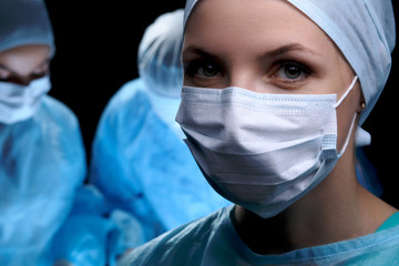 Medical team performing operation. Focus at female doctor 