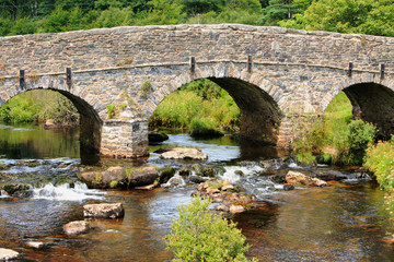 Fototapeta na wymiar Post Bridge in Dartmoor is an old roman bridge and is a popular tourist attraction, Devon