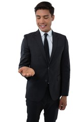Smiling businessman looking at palm of hand