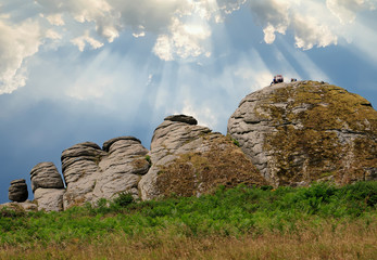 Hayton Rocks in Dartmoor with shafts of light coming through the clouds