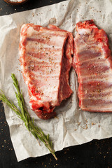 Raw pork ribs with spices, salt and rosemary