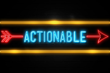 Actionable  - fluorescent Neon Sign on brickwall Front view