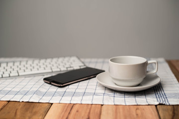 Business concept. Office supply on desk table with cup of coffee and analysis chart, smartphone, keyboard, notebook, on desk.