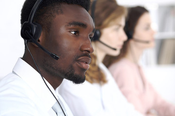 African american call operator in headset. Call center business or customer service concept