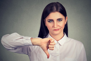 Angry woman giving thumbs down gesture