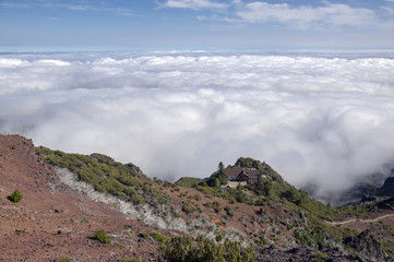 Fototapeta na wymiar Pico Ruivo hiking, above clouds, amazing magic landscape, incredible views, sunny weather with low clouds, island Madeira, Portu