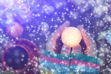 A man holds a candle in his hand. Christmas, new year.