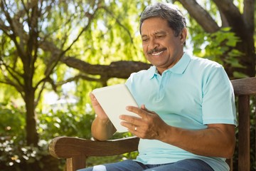 Fototapeta premium Senior man using digital tablet
