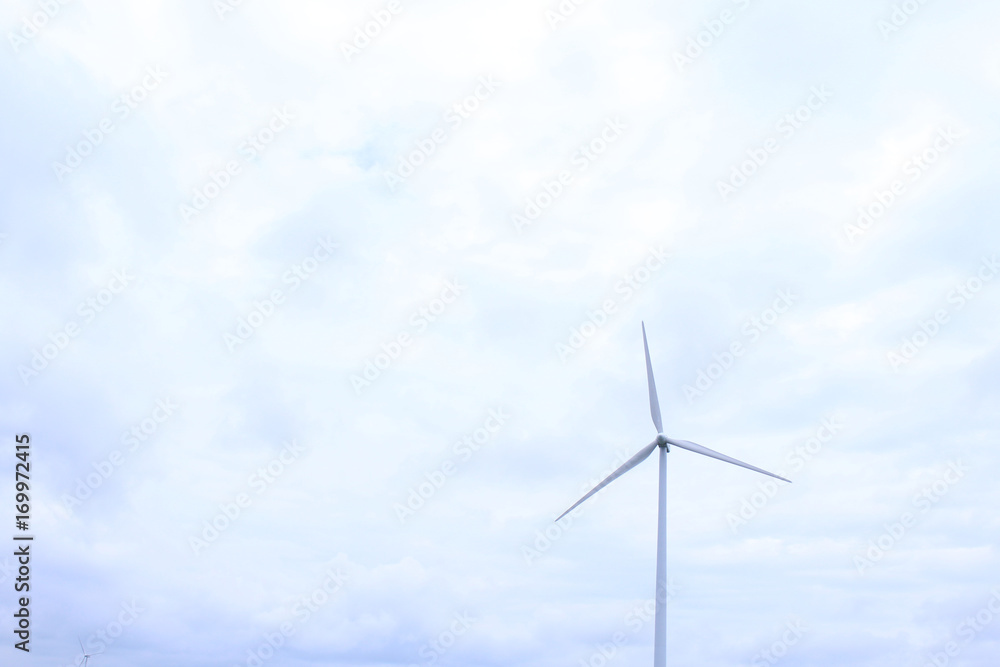 Wall mural modern wind mill with heavy clouds in the distance