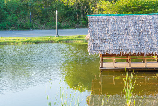Hut on river in public park with reflex in water