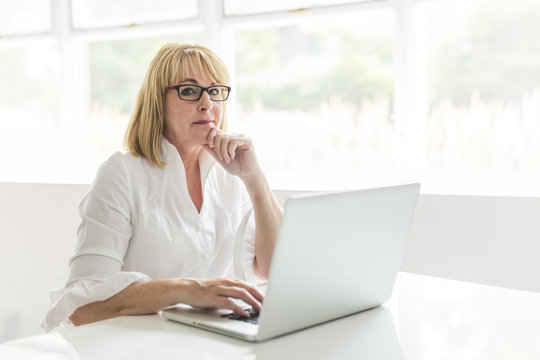 mature woman using laptop at home