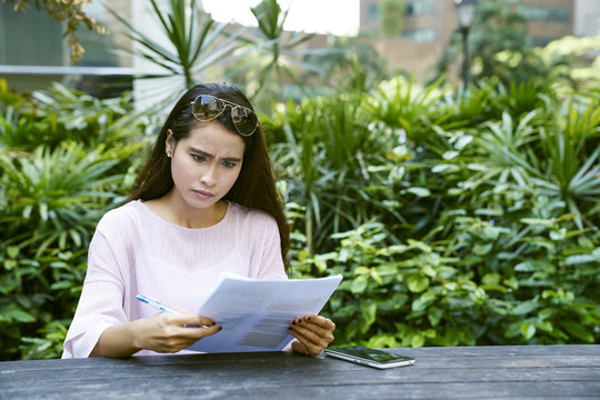 Young Malay Lady Frustrated At The Documents She Is Looking At