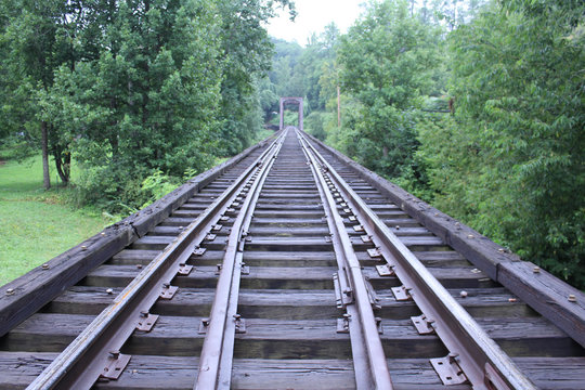Train Tracks Bridge Crossing Rivier in the Deep Woods