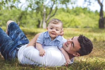 Fototapeta premium beautiful father little toddler son on the meadow.
