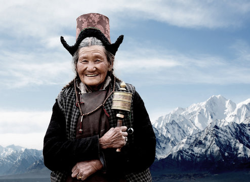 Traditional woman holding prayer wheel. Ladakh. India