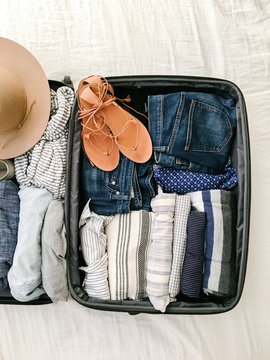 Suitcase with packed clothes and accessories