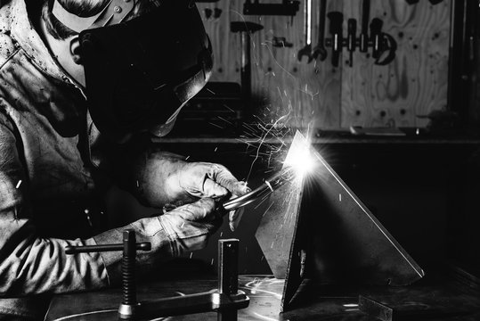 Close up black and white image of welder