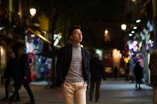 Casual young chinese man in madrid at night