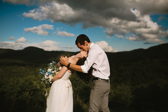 Happy Couple Kissing on Mountaintop