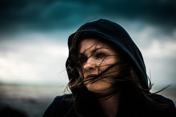 Portrait of a woman in a hood like a sith. Dark soul.