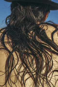 man's back covered in long black hair