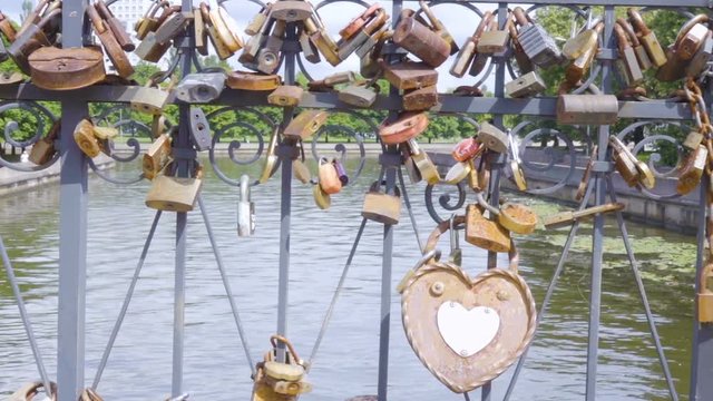 Love padlocks on the bridge. Wedding locks on a metal fencing. Love locks that couples hand on bridges to symbolize their true love.
