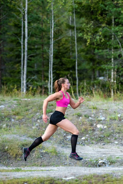 A young woman runing in the forest