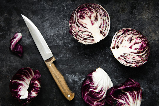 Halved radicchio on dark metal background