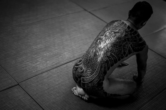 Japanese man formally presenting his fully tattooed back