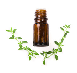 Bottle of essential oil with herbs thyme isolated on white background