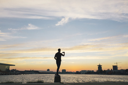 Man making a photo of the waterfront during dusk or sunset