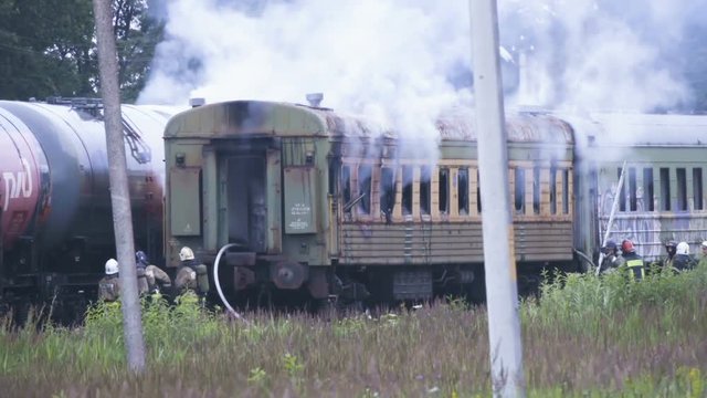 Fire at railway station. Firefighters extinguish railway car. Firemen in action. Railway freight train. Fire truck. Emergency Situations Ministry. Rescue service 911. Kaliningrad - July 2017 Russian.