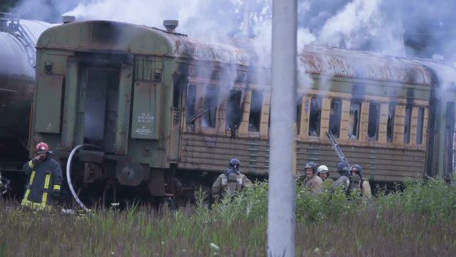 Fire at railway station. Firefighters extinguish railway car. Firemen in action. Railway freight train. Fire truck. Emergency Situations Ministry. Rescue service 911. Kaliningrad - July 2017 Russian.