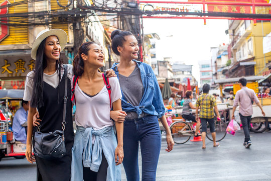 Three pretty asian girls are walking around and having fun in Chinatown, Bangkok