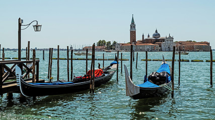 Fototapeta na wymiar Gondolas in Venice, Italy on the background of the San Giorgio Maggiore Church