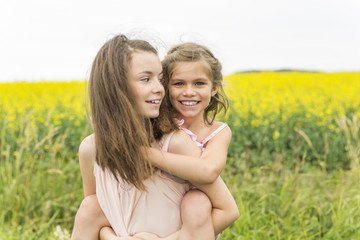 beautiful girls in a field of yellow flowers