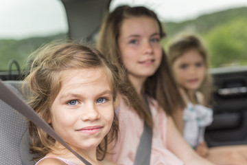 Fototapeta na wymiar little girls inside car